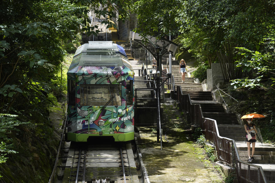 A Peak Tram passes uphill of the Victoria Peak in Hong Kong on June 16, 2021. Hong Kong’s Peak Tram is a fixture in the memories of many residents and tourists, ferrying passengers up Victoria Peak for a bird’s eye view of the city’s many skyscrapers. (AP Photo/Vincent Yu)