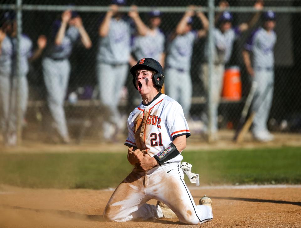 Sprague's Chris Rogers (21) screams as he slides into home plate during the playoff game against Sunset on Monday, May 23, 2022, in Salem, Ore.