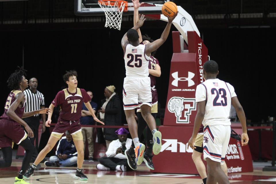 St. Francis Prep Oesoemana Sacko (25, white) puts up a shot during the CHSAA AA city quarterfinals at Fordham University on March 5, 2023.