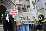 Supporters of Julian Assange stage a demonstration outside the High Court in London, Thursday, Oct. 28, 2021. The U.S. government is scheduled to ask Britain's High Court to overturn a judge's decision that WikiLeaks founder Julian Assange should not be sent to the United States to face espionage charges. A lower court judge refused extradition in January on health grounds, saying Assange was likely to kill himself if held under harsh U.S. prison conditions. (AP Photo/Frank Augstein)