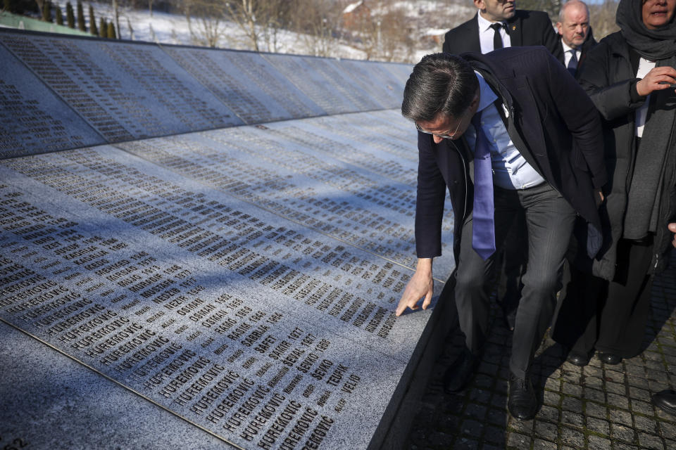 Prime Minister of the Netherlands, Mark Rutte, touches the monument with names of those killed in Srebrenica genocide at the Srebrenica Memorial Center in Potocari, Bosnia, Monday, Jan. 22, 2024. (AP Photo/Armin Durgut)