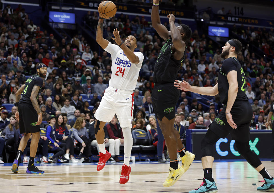 Los Angeles Clippers guard Norman Powell (24) drives to the basket in front of New Orleans Pelicans forward Zion Williamson, center right, in the first half of an NBA basketball game in New Orleans, Friday, Jan. 5, 2024. (AP Photo/Tyler Kaufman)