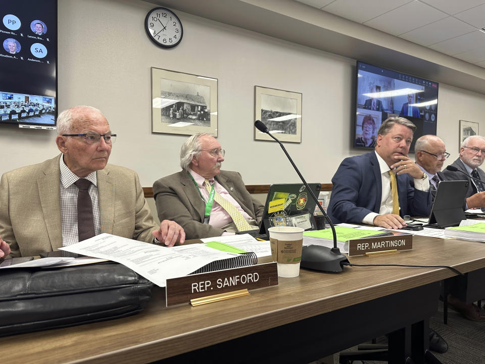 North Dakota Republican state, from left, Reps. Mark Sanford, Bob Martinson and Mike Nathe attend a meeting of the Legislature's Budget Section, Thursday, June 29, 2023, at the state Capitol in Bismarck, N.D. The three lawmakers sit on a panel that wrote the 2023-25 budget for North Dakota's higher education system. Sanford also chairs the Legislature's interim Higher Education Committee, which will be exploring issues of potential impacts from Minnesota's North Star Promise tuition program. (AP Photo/Jack Dura)