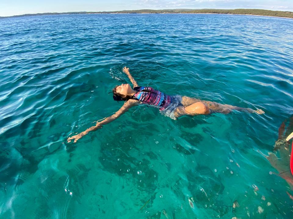 Girl swimming in blue water