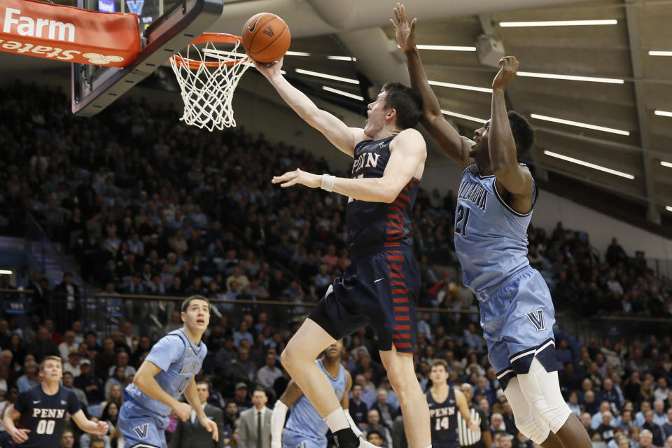Pennsylvania's AJ Brodeur, center, goes up for a shot past Villanova's Dhamir Cosby-Roundtree during the first half of an NCAA college basketball game Wednesday, Dec. 4, 2019, in Villanova, Pa. (AP Photo/Matt Slocum)