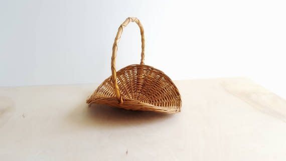 Store magazine, fire wood, or even knitting accessories in <a href="https://www.etsy.com/listing/629060886/vintage-farmhouse-harvest-basket-flower?ga_order=most_relevant&amp;ga_search_type=all&amp;ga_view_type=gallery&amp;ga_search_query=woven%20baskets&amp;ref=sr_gallery-1-6" target="_blank" rel="noopener noreferrer">this unique vintage farmhouse basket</a> to add a touch of personality to your space.