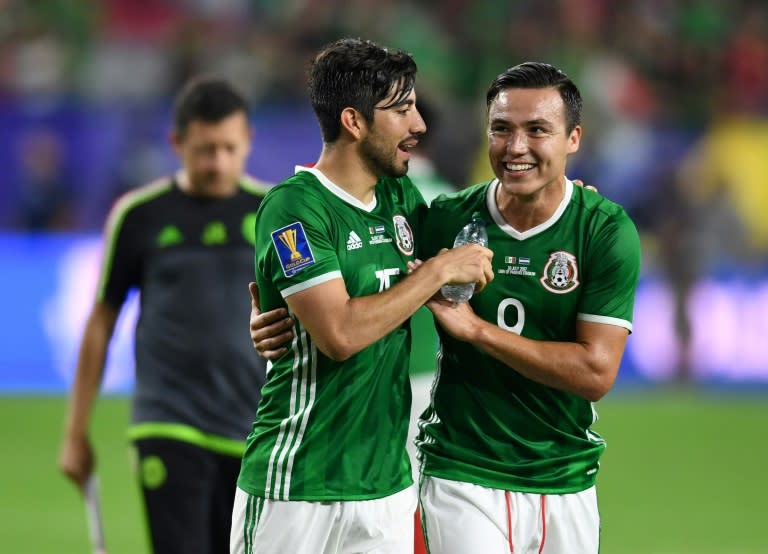 Mexico's Rodolfo Pizarro (L) and Erick Torres celebrate their 1-0 victory over Honduras in the CONCACAF Gold Cup quarter-final match, at the University of Phoenix Stadium in Glendale, Arizona, on July 20, 2017