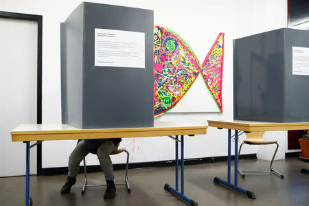 A German citizen casts his vote for the German federal election in Berlin, Germany, September 24, 2017. REUTERS/Axel Schmidt