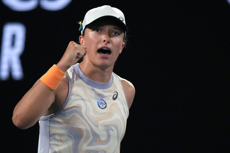 Iga Swiatek of Poland celebrates after defeating Jule Niemeier of Germany in their first round match at the Australian Open tennis championship in Melbourne, Australia, Monday, Jan. 16, 2023. (AP Photo/Aaron Favila)