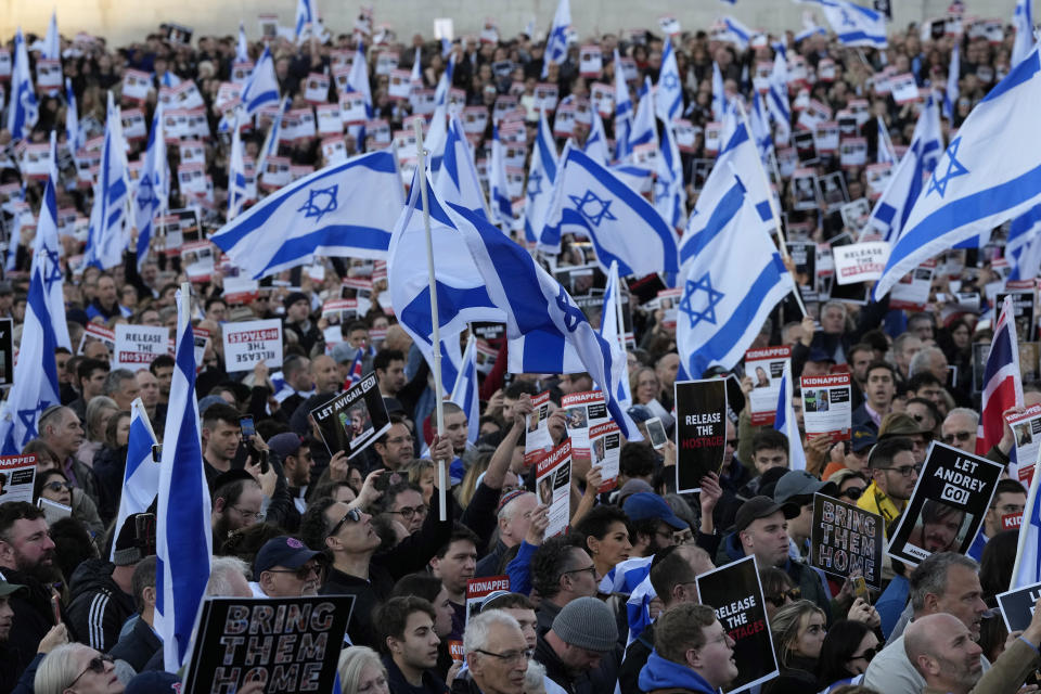 People carry Israeli flags and pictures of people believed taken hostage and held in Gaza, during a protest in Trafalgar Square, London, Sunday, Oct. 22, 2023. They are demanding the release of all hostages allegedly taken by the militant group Hamas. (AP Photo/Frank Augstein)