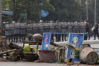 Myanmar riot police with shields move forward during a protest against the military coup in Mandalay, Myanmar, Sunday, Feb. 28, 2021. Police fired tear gas and water cannons and there were reports of gunfire Sunday in Myanmar's largest city Yangon where another anti-coup protest was underway with scores of students and other demonstrators hauled away in police trucks. (AP Photo)