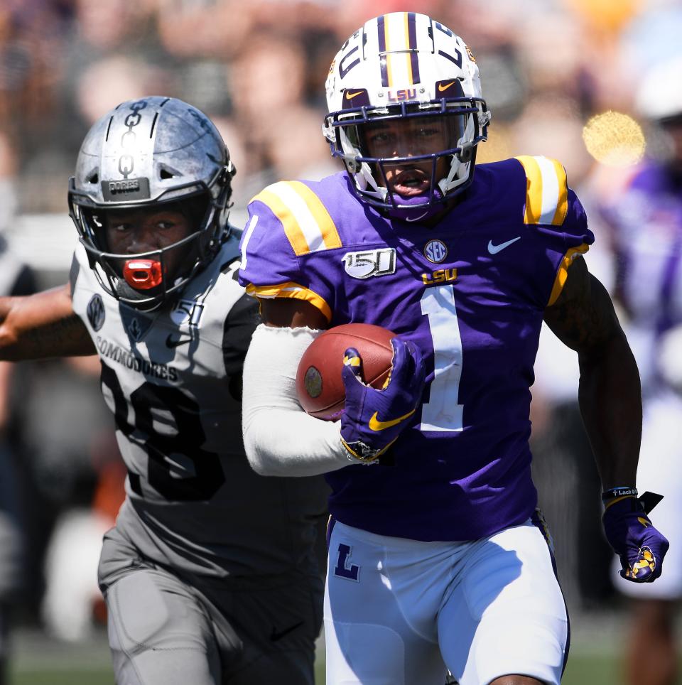 LSU wide receiver Ja'Marr Chase (1) races past Vanderbilt defensive back Allan George (28) for a touchdown in the second quarter during their game at Vanderbilt Stadium Saturday, Sept. 21, 2019 in Nashville , Tenn. .