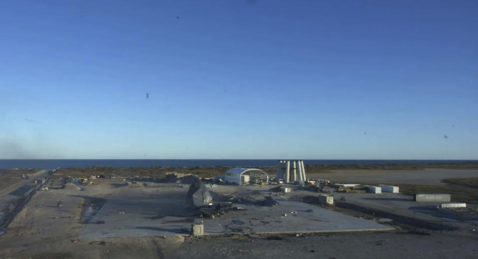 In this screen grab from video posted by SpaceX, the remains of the company's Starship are seen after it became engulfed in flames and ruptured upon touching down after a test flight, Wednesday, Dec. 9, 2020, in a remote area of Texas. (SpaceX via AP)