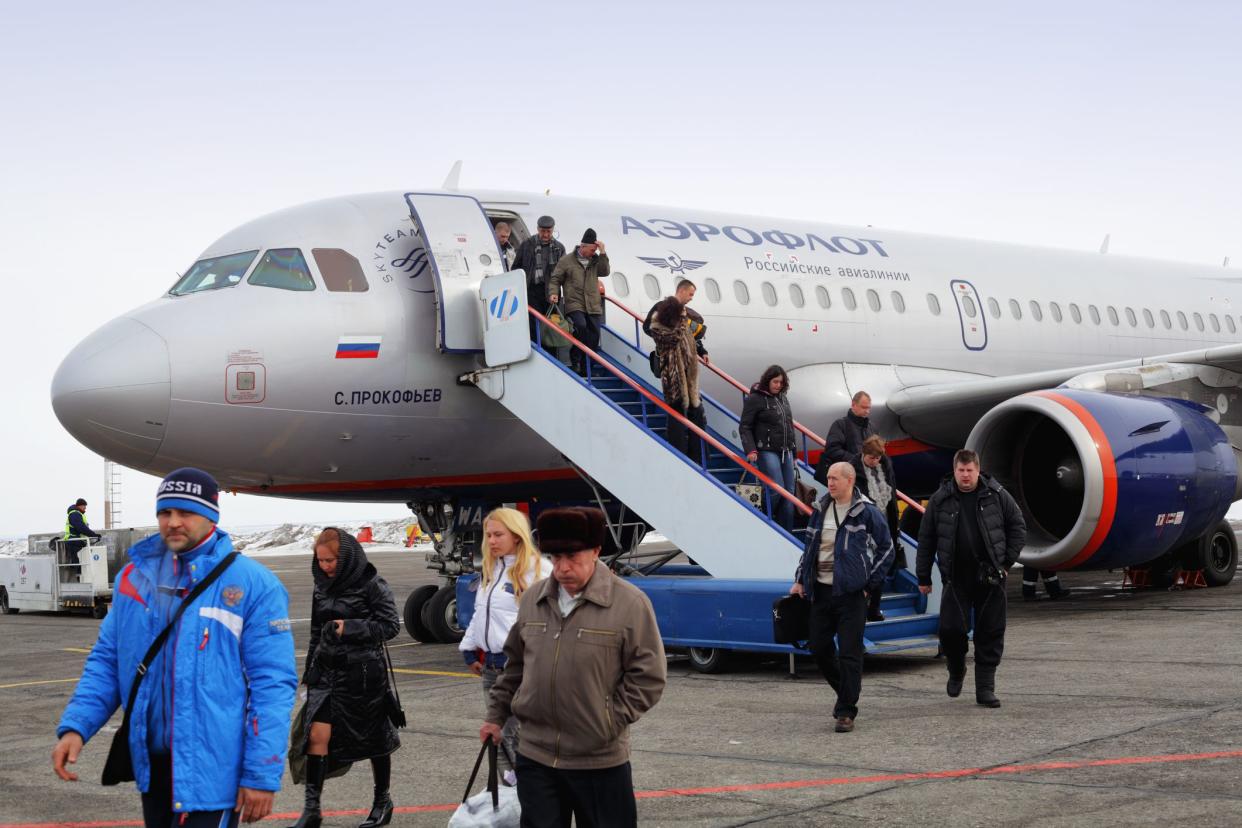 Samara, Russia - March 10, 2013: Passengers walking down the steps of the passenger airplane Airbus A319 arrived from Moscow and going to a runway airport shuttle at the Samara Kurumoch airport (IATA: KUF, ICAO: UWWW). The airplane Airbus A319 named