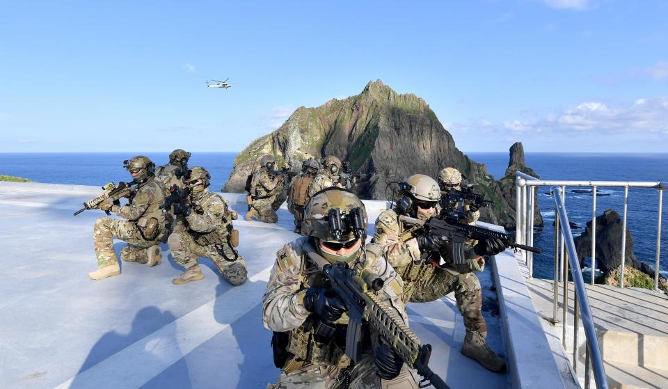 In this photo provided by South Korea's Navy, members of South Korean Navy's special forces participate during the drill on the islets called Dokdo in Korean and Takeshima in Japanese, Sunday, Aug. 25, 2019. In a development that could possibly further complicate ties between Seoul and Tokyo, South Korea's navy on Sunday began two-day exercises on and around a group of islets controlled by South Korea but also claimed by Japan. (South Korea's Navy via AP)