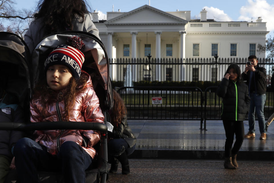 Tourists visit the White House with her family, Friday March 22, 2019, in Washington, as news breaks that special counsel Robert Mueller has concluded his investigation into Russian election interference and possible coordination with associates of President Donald Trump. The Justice Department says Mueller delivered his final report to Attorney General William Barr, who is reviewing it. Mueller's report, still confidential, sets the stage for big public fights to come. The next steps are up to Trump's attorney general, to Congress and, in all likelihood, federal courts. (AP Photo/Jacquelyn Martin)