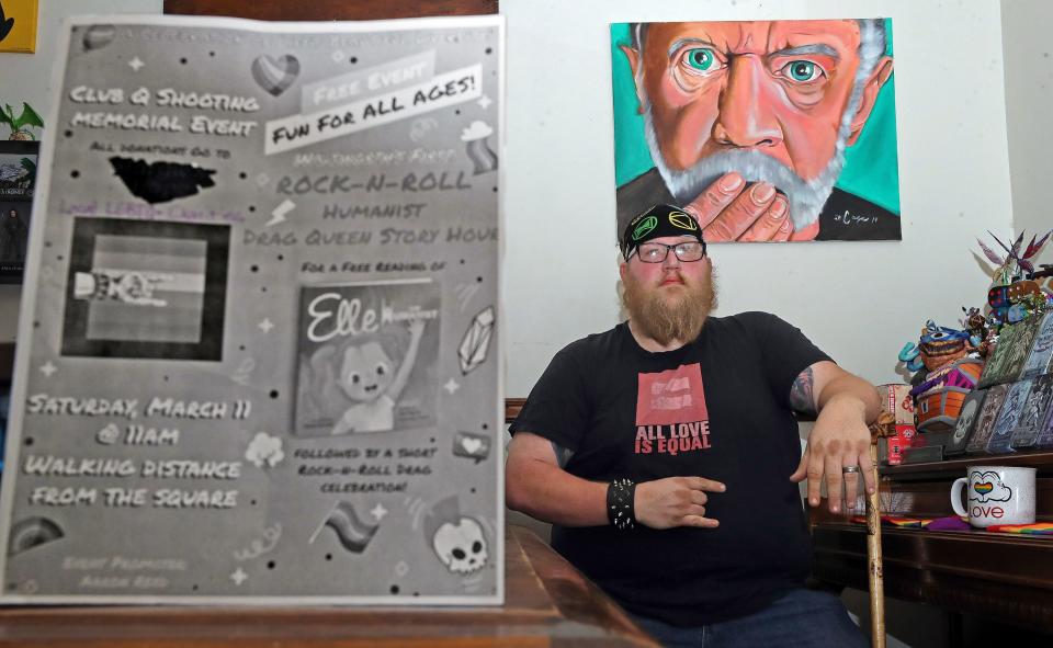 Aaron Reed poses for a portrait next to a flyer for his free Humanist Drag Queen Story Hour event that he hopes to have on March 11 in Wadsworth.