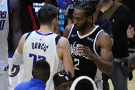 Dallas Mavericks guard Luka Doncic (77) talks with Los Angeles Clippers forward Kawhi Leonard (2) after Game 7 of an NBA basketball first-round playoff series Sunday, June 6, 2021, in Los Angeles, Calif. The Clippers won the game 126-111, and the series 4-3. (AP Photo/Ashley Landis)