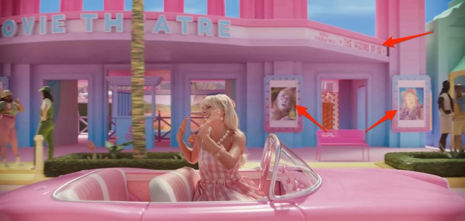 Barbie driving by a movie theater that's playing "The Wizard of Oz" in "Barbie."