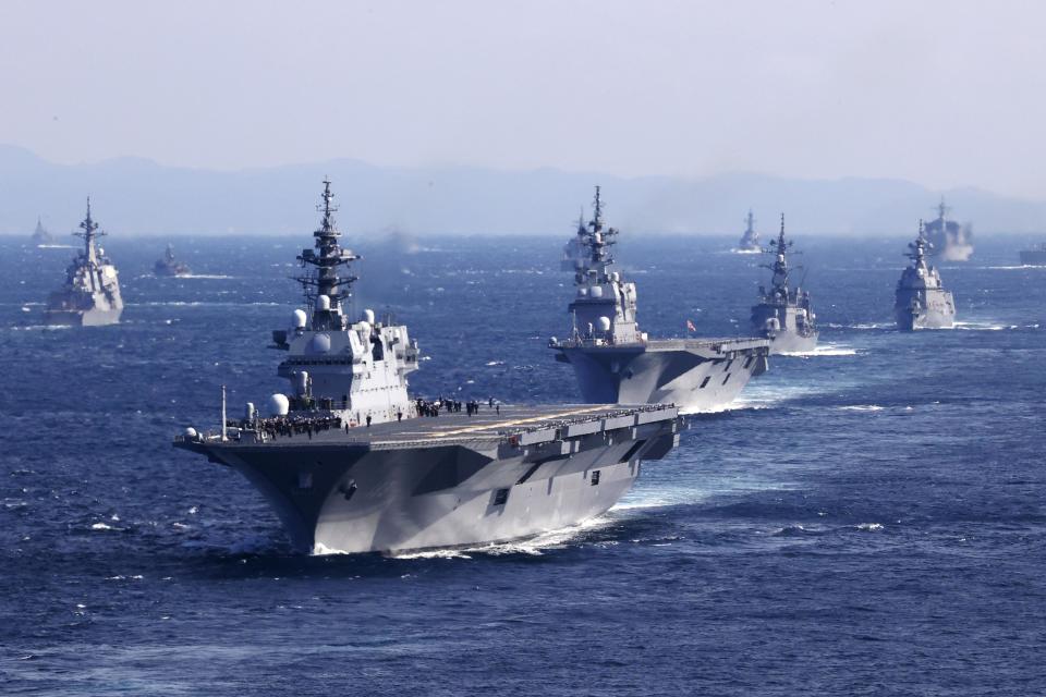 Japan's Maritime Self-Defense Force helicopter carrier JS Izumo, front, and other warships join an international fleet review in Sagami Bay, south of Tokyo, Sunday, Nov. 6, 2022. Eighteen warships participated from 12 countries, including the United States, Australia, Canada, India, New Zealand, Singapore and South Korea, while the United States and France also sent warplanes for the review. (Kyodo News via AP)