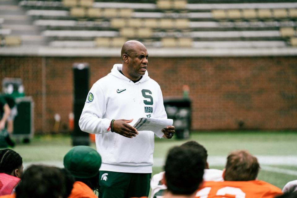 Michigan State coach Mel Tucker speaks to his team during practice on Sunday, Dec. 26, 2021, in Atlanta.