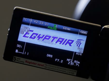 The company logo is displayed on a video camera screen at the Egyptair desk at Charles de Gaulle airport, after an Egyptair flight disappeared from radar during its flight from Paris to Cairo, in Paris, France, May 19, 2016. REUTERS/Christian Hartmann/File Photo