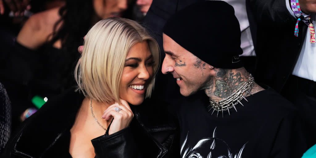 kourtney kardashian and travis barker smiling at each other