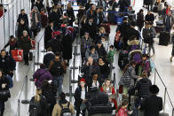 Travelers check in for flights at John F. Kennedy International Airport, Wednesday, Nov. 21, 2018, in New York. The airline industry trade group Airlines for America expects that Wednesday will be the second busiest day of the holiday period behind only Sunday, when many travelers will be returning home after Thanksgiving. (AP Photo/Mark Lennihan)