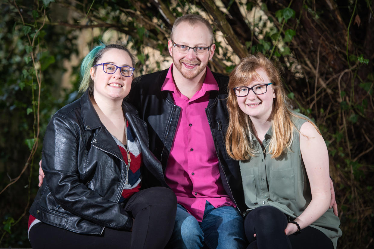 A married couple have become a throuple after a woman fell in love with her female colleague, pictured [L-R] Megan Ripley, 30, Sean Ripley, 33, and Louise Jackson, 22. (Caters) 