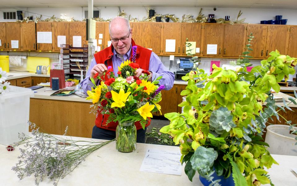 Store manager Linn Elliott creates a colorful arrangement at Becks Florist in East Peoria. Elliott knew Greg Becks for more than 40 years and worked for his father and grandfather.