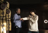 This image released by Warner Bros. Pictures shows director Denis Villeneuve, left, with actor Timothee Chalamet on the set of "Dune." (Chia Bella James/Warner Bros. Pictures via AP)