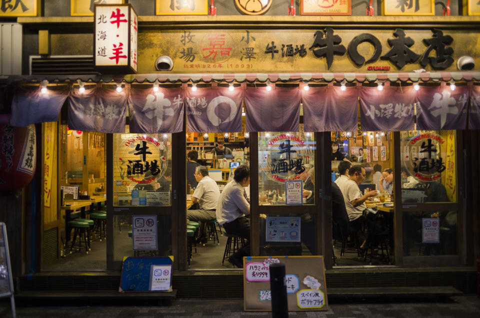 People eat and drink at a restaurant before 8 p.m., the closing time suggested by the government for the ongoing state of emergency in Tokyo, Thursday, Sept. 30, 2021. On Friday, Oct. 1, 2021, Japan fully came out of a coronavirus state of emergency for the first time in more than six months as the country starts gradually easing virus measures to help rejuvenate the pandemic-hit economy as the infections slowed.(AP Photo/Hiro Komae)