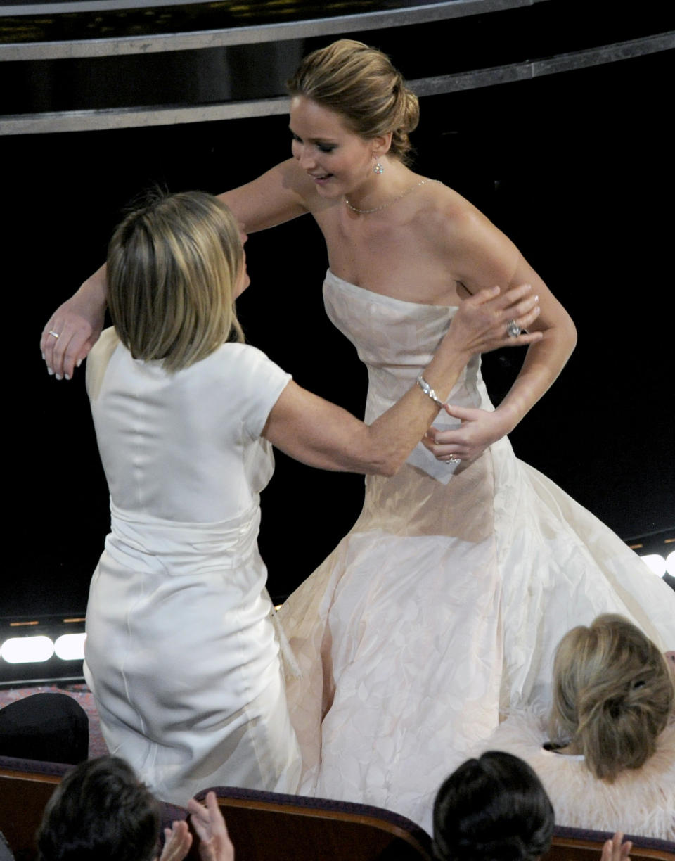 Karen Lawrence, left, congratulates her daughter Jennifer Lawrence after she is announced as the winner of the award for best actress in a leading role for