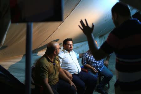 Muntazer al-Zaidi, a candidate on the Sairun list, speaks with people in the Sadr City district of Baghdad, Iraq May 10, 2018. Picture taken May 10, 2018. REUTERS/Thaier al-Sudani