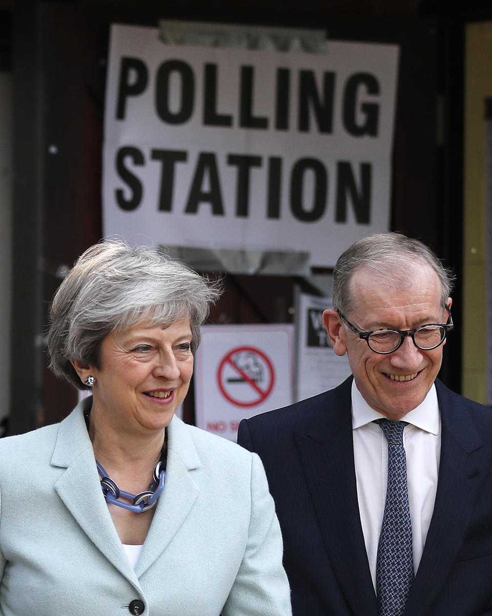 Britain's Prime Minister Theresa May and her husband Philip leave a polling station after voting in the European Elections in Sonning, England, Thursday, May 23, 2019.(AP Photo/Frank Augstein)