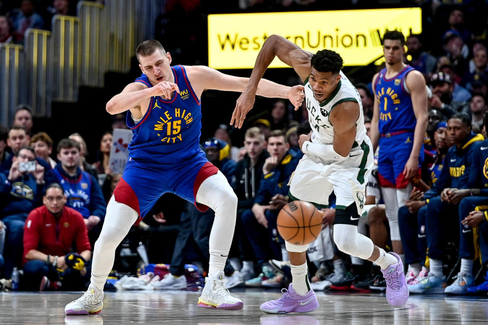 DENVER, CO - MARCH 25:  Giannis Antetokounmpo #34 of the Milwaukee Bucks steals the ball from Nikola Jokic #15 of the Denver Nuggets in the second half of a game at Ball Arena on March 25, 2023 in Denver, Colorado. NOTE TO USER: User expressly acknowledges and agrees that, by downloading and or using this photograph, User is consenting to the terms and conditions of the Getty Images License Agreement. (Photo by Dustin Bradford/Getty Images)