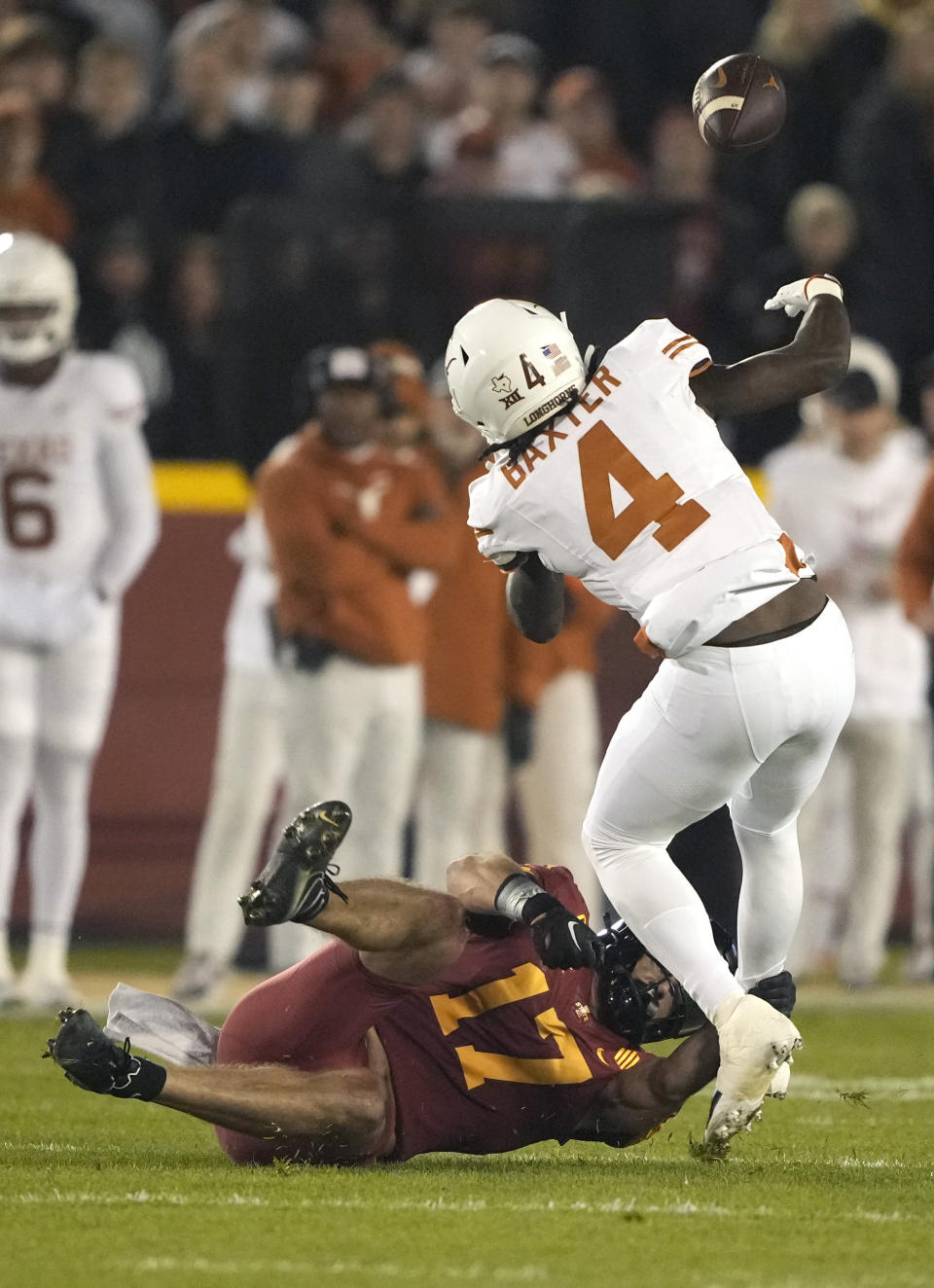 Iowa State defensive back Beau Freyler (17) pops loose the ball from Texas running back CJ Baxter (4) during the first half of an NCAA college football game, Saturday, Nov. 18, 2023, in Ames, Iowa. (AP Photo/Matthew Putney)