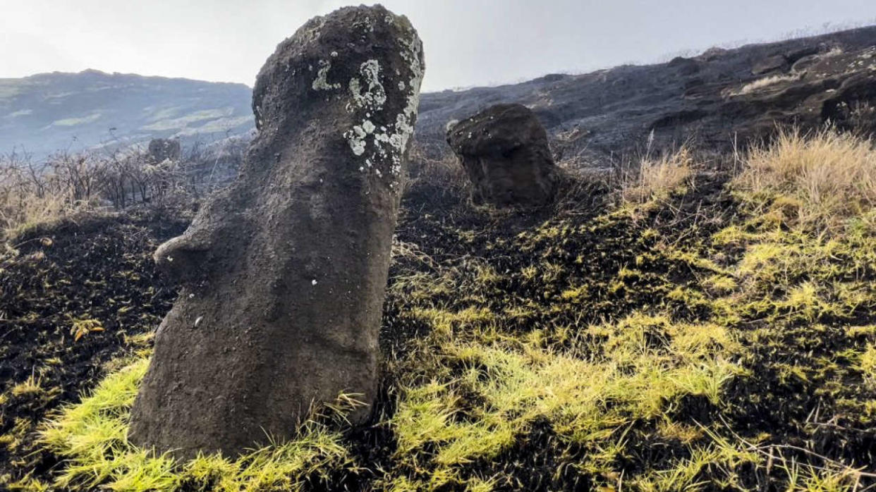 This handout picture released by the Rapanui Municipality shows Moais -- stone statues of the Rapa Nui culture -- affected by a fire at the Rapa Nui National Park in Easter Island, Chile, on October 6, 2022. (Photo by Rapanui Municipality / AFP) / RESTRICTED TO EDITORIAL USE - MANDATORY CREDIT 