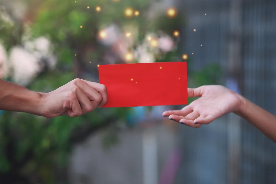 The elders hand give red envelope 