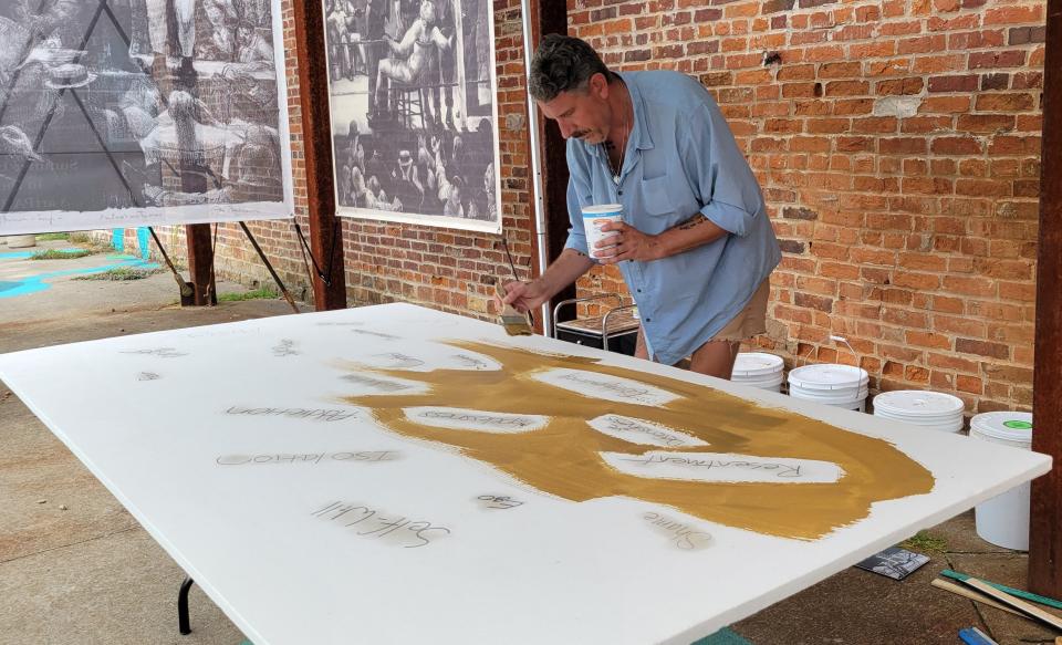 Peter Wolfgang works on a piece for display in October at the artPARK on Main Street by the Pomerene Center for the Arts. Wolfgang will be doing four work sessions and talking with visitors through September part of an exhibit for National Recovery Month.