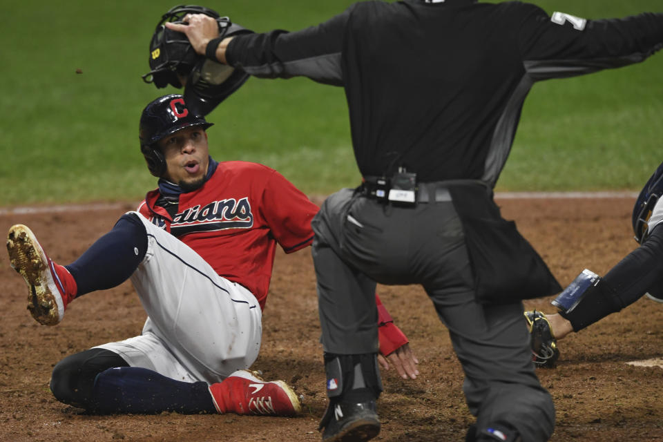 Cleveland Indians' Cesar Hernandez reacts after being called safe at home during the fifth inning of Game 2 of the team's American League wild-card baseball series against the New York Yankees, Wednesday, Sept. 30, 2020, in Cleveland. (AP Photo/David Dermer)