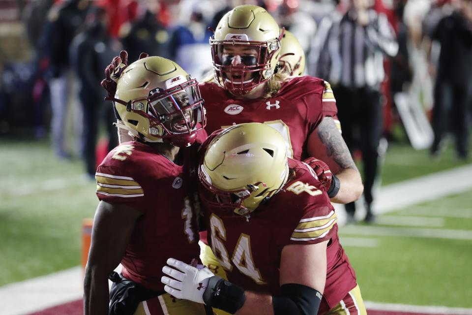 Boston College wide receiver CJ Lewis, left, celebrates his touchdown during the second half of the team's NCAA college football game against Louisville, Saturday, Nov. 28, 2020, in Boston. (AP Photo/Michael Dwyer)