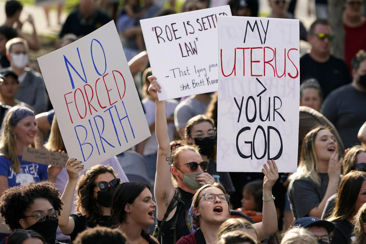 Pro-abortion-rights protesters holding signs at a rally.