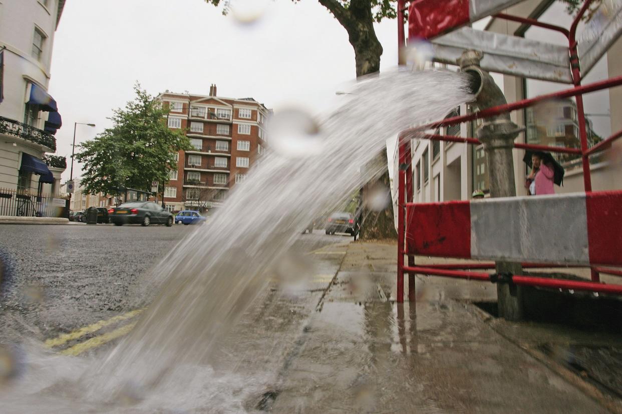 LONDON - MAY 16:  A burst pipe spews water onto a street near Lancaster Gate on May 16, 2006 in London, England. One of the driest periods in 70 years has caused restrictions on non-essential use of water to be imposed in the Southeast of England. The restrictions include bans on filling of privately owned swimming pools, watering of gardens & allotments, parks and recreation surfaces.  (Photo by Scott Barbour/Getty Images)