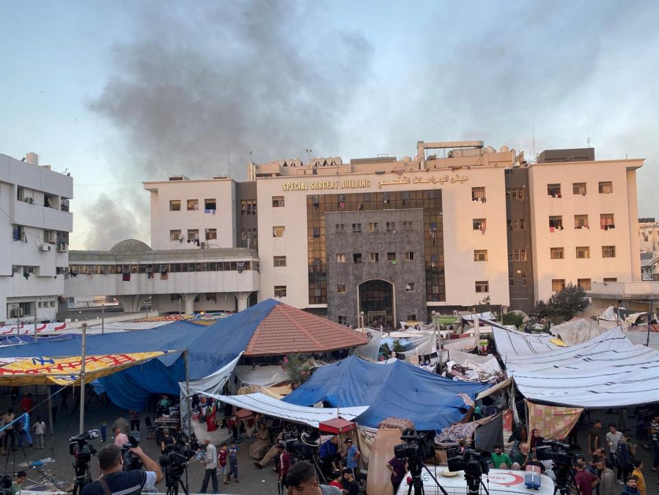 Smoke rises as displaced Palestinians take shelter at al-Shifa hospital (Reuters)