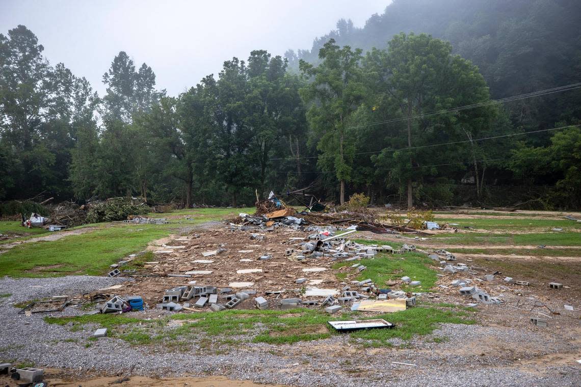 Cinderblocks are scattered around a lot on Thursday, Aug. 4, 2022, where a house was washed away during flash flooding along Troublesome Creek near Dwarf, Ky.