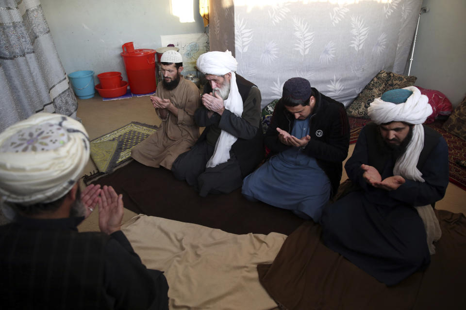 In this Saturday, Dec. 14, 2019, photo, jailed Taliban pray inside the Pul-e-Charkhi jail after an interview with The Associated Press in Kabul, Afghanistan. Thousands of Taliban prisoners jailed as insurgents see a peace deal being hammered out in Qatar as their ticket to freedom. Prisoner release is a key pillar of any agreement the U.S. strikes with the Taliban to end Afghanistan’s 18-year war.(AP Photo/Rahmat Gul)