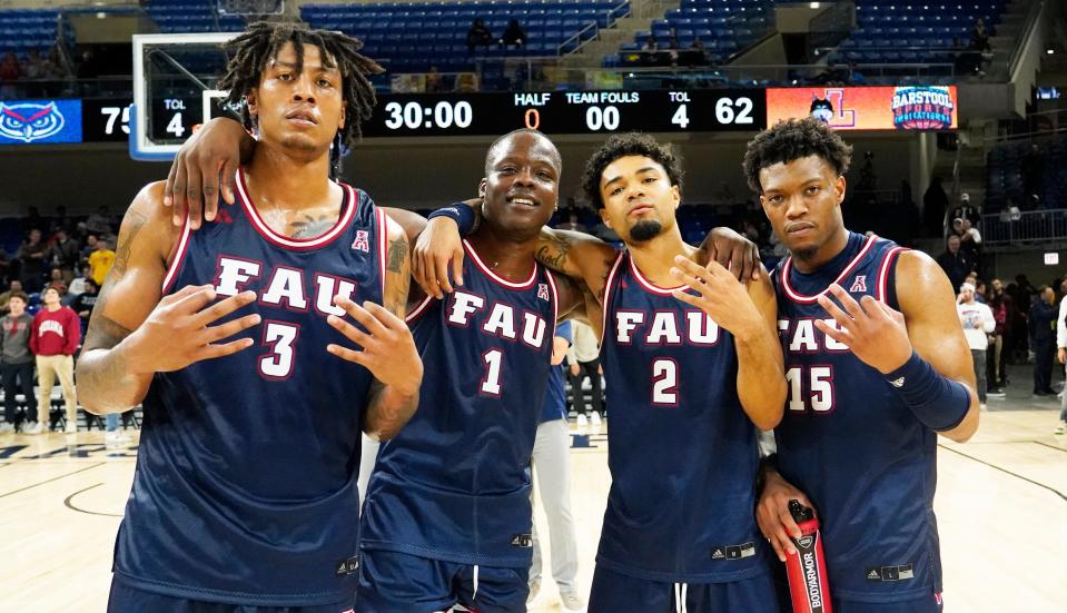 Nov 8, 2023; Chicago, Illinois, USA; Florida Atlantic Owls forward Giancarlo Rosado (3) guard Johnell Davis (1) guard Nicholas Boyd (2) and Nicholas Boyd (2) celebrate their win against the Loyola Ramblers at Wintrust Arena. Mandatory Credit: David Banks-USA TODAY Sports