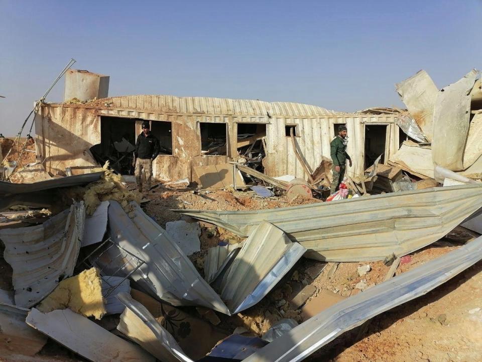 Fighters from the Kataeb Hezbollah, or Hezbollah Brigades militia, inspect the destruction of their headquarters in the aftermath of a U.S. airstrike in Qaim, Iraq, Monday, Dec. 30, 2019. The Iranian-backed militia said Monday that the death toll from U.S. military strikes in Iraq and Syria against its fighters has risen to 25, vowing to exact revenge for the "aggression of evil American ravens." (AP Photo)