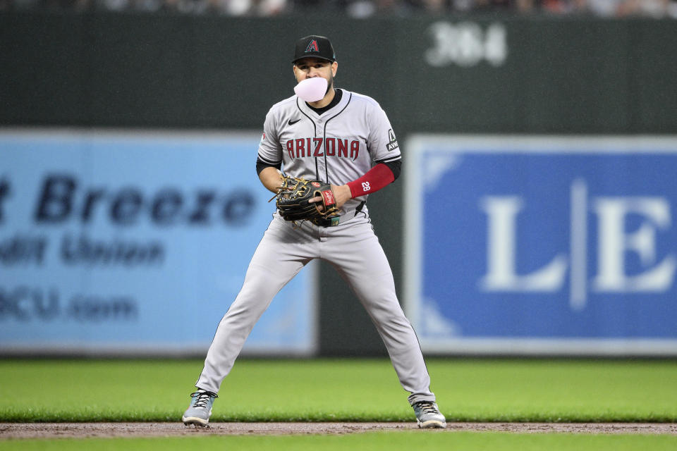 Arizona Diamondbacks third baseman Eugenio Suarez blows a gum bubble as he waits for a play during the second inning of a baseball game against the Baltimore Orioles, Friday, May 10, 2024, in Baltimore. (AP Photo/Nick Wass)